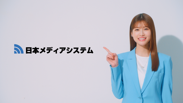 ７.社名を指差しながら伝える生見さん。