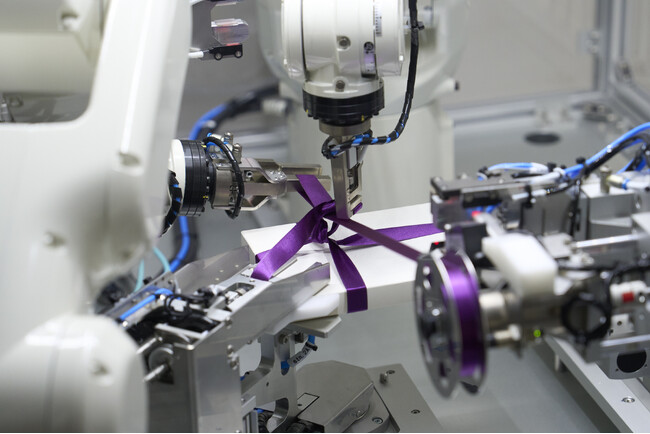 Examples of equipment developed by Abilica Automatic ribbon-tie tying machine for gift boxes