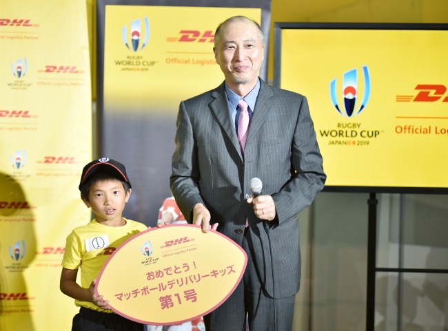 DHLジャパン社長の山川（右）とキッズ第一号に決まった山村君（左）