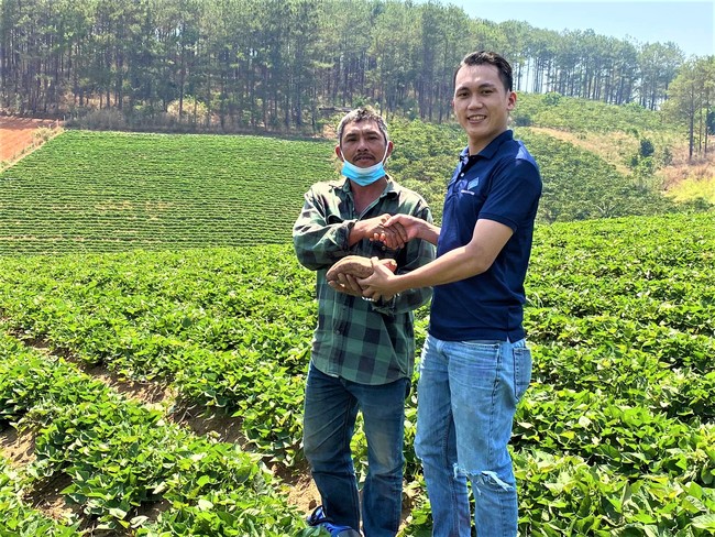 さつま芋生産者のタンさん（左）と当社ベトナム子会社のスタッフ（右）