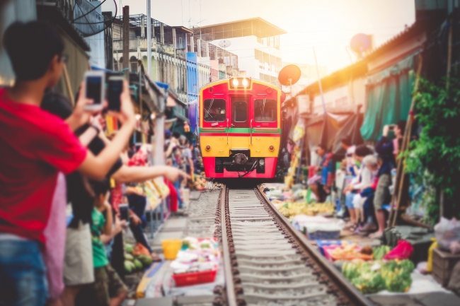 とんでもない場所に市場つくったな… 「メークロン市場」を列車に乗って通過する／タイ