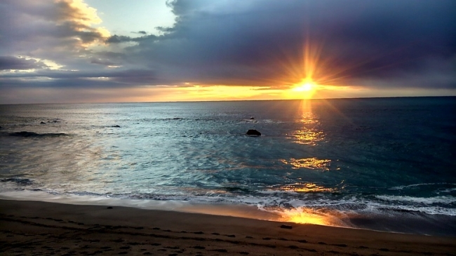 和田浦海岸にて。雲の切れ間から見えた初日の出。水面に輝く朝日は幻想的です。