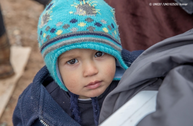 帽子などの支援物資を受け取ったシリア難民の男の子。(2018年2月撮影) © UNICEF_UN0162509_Anmar