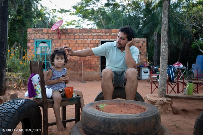 2歳の娘に朝食を与えるパラグアイの父親。(2019年5月撮影) © UNICEF_UN0312696_Sokol