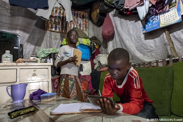 唯一自宅に一台ある携帯電話を使って、勉強に取り組む11歳のサムエルくん(右)とジャネットさん(左)兄妹。(ケニア、2020年7月撮影) © UNICEF_UNI362244_Everett