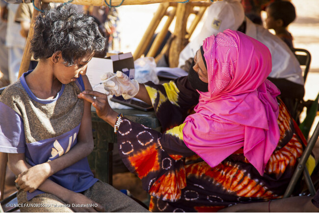 メナカの国内避難民キャンプで行われた予防接種キャンペーンで、COVAXを通じて届いた新型コロナウイルス感染症のワクチン接種を受けるマダニさん。(マリ、2022年12月撮影) (C) UNICEF_UN0805506_Fatoumata Diabate_WHO