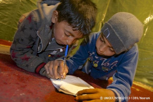 シリアから避難し、レバノンの非公式テント居住区に身を寄せている子どもたち。家族が暮らすテントの中でアルファベットの練習をしている様子。© UNICEF/NYHQ2013-1389/Noorani