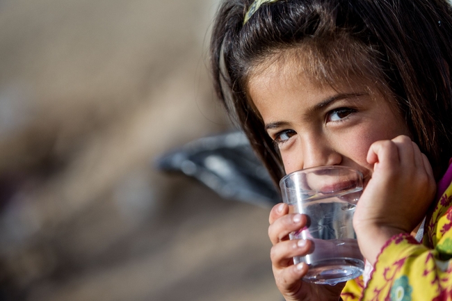 ユニセフが支援して出来た水のみ場で水を飲む女の子（イラク・ドミズ難民キャンプ）© UNICEF/UKLA2012-00946/KARIN SCHERMBRUCKER 