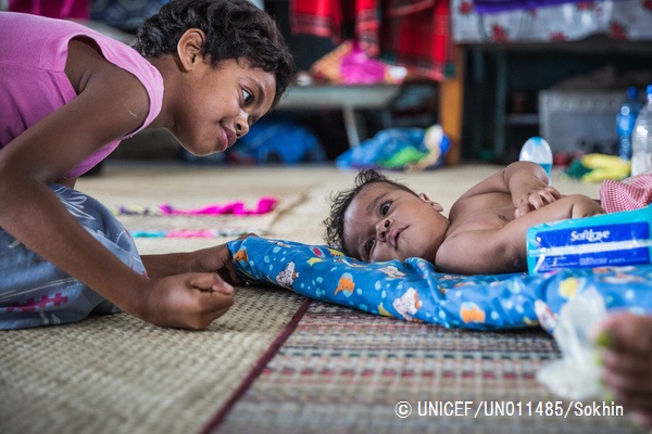 小学校の避難所で7カ月の赤ちゃんと遊ぶ9歳の女の子。サイクロンで多くの子どもたちが避難生活を強いられている。© UNICEF_UN011485_Sokhin