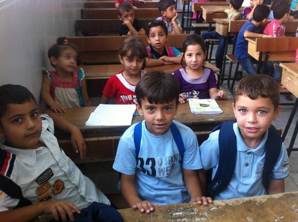 シリア国内の都市・ダルアーにあるユニセフが支援している学校で英語の授業を受ける男の子たち。© UNICEF Syria/2013/Kanawati