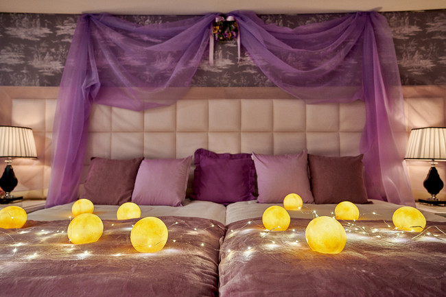 ベッド上に飾られた丸いランタンが部屋を照らし、ロマンチックな雰囲気を演出。