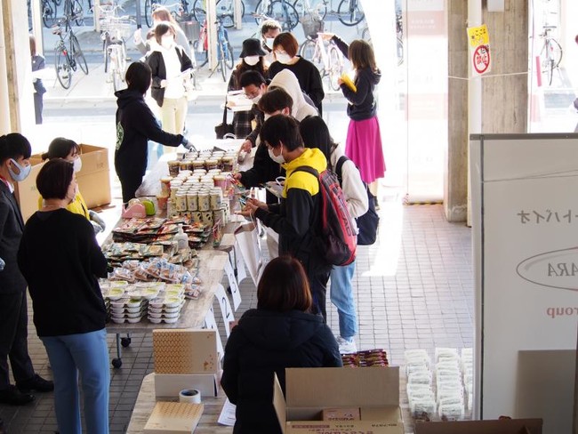 岡山大学津島キャンパスでの支援食糧品配付に集まる留学生ら
