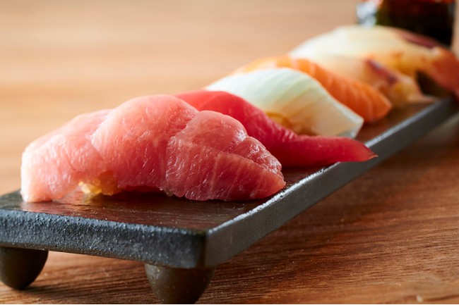 リピーター続出の寿司は不動の人気本マグロ他日替わりの新鮮なネタがずらりと並ぶ